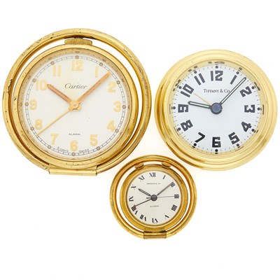 Lot 1271 - Three Cartier and Tiffany & Co. Gilt-Metal Travel Clocks
