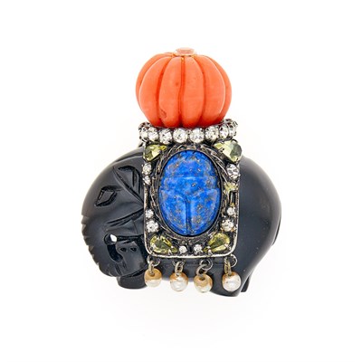 Lot 1047 - Iradj Moini Gilt-Metal Carved Jet, Coral, Lapis, Imitation Pearl and Paste Elephant Brooch