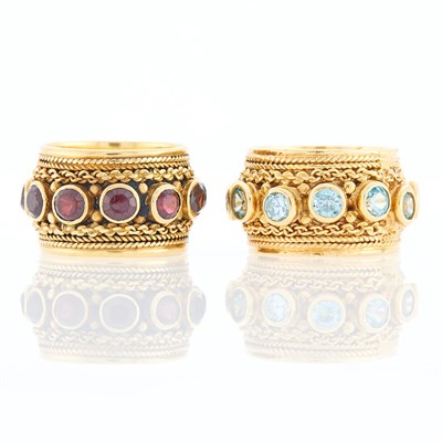 Lot 1187 - Two Wide Gold, Garnet and Blue Topaz Band Rings