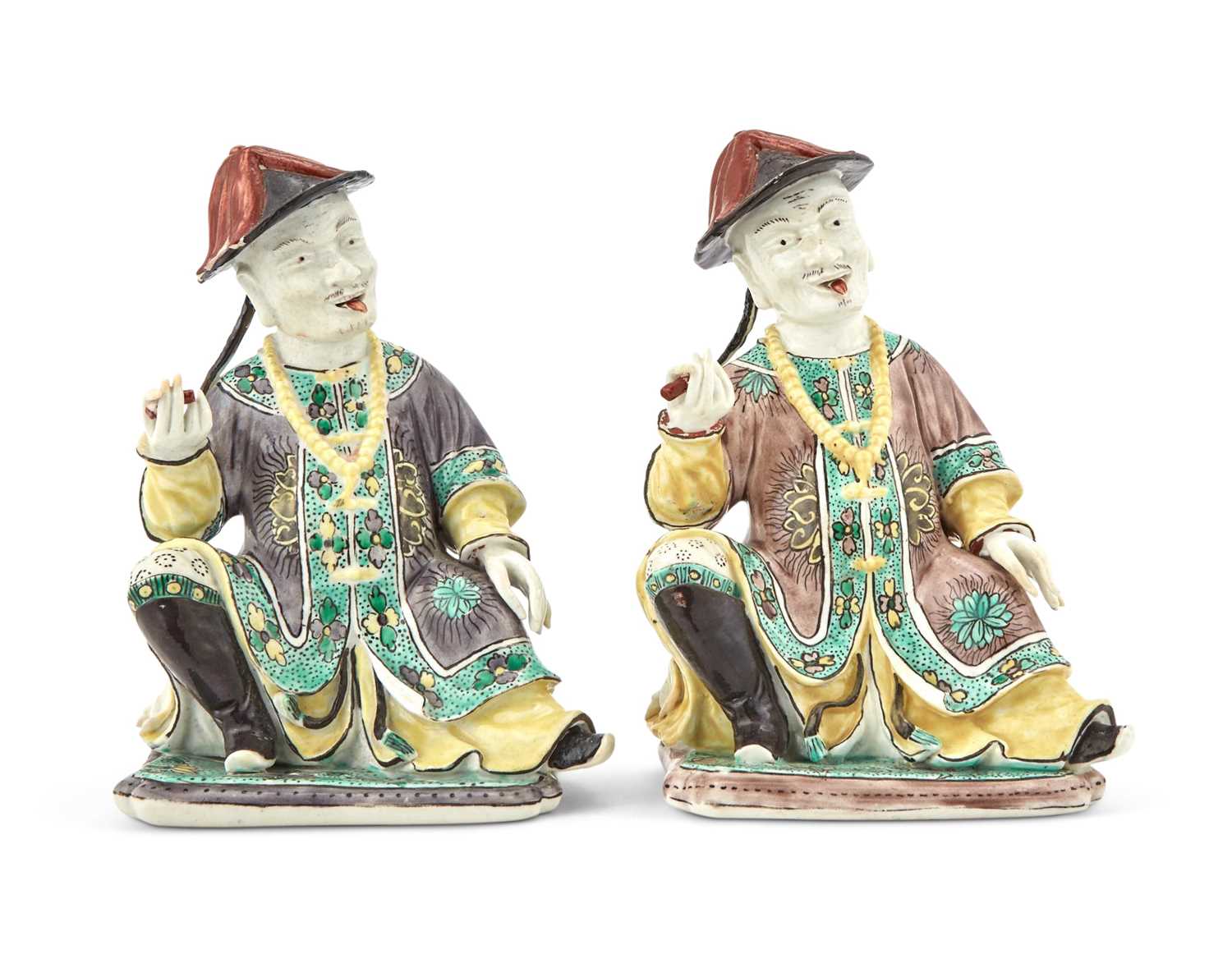 Lot 361 - Two French Enameled Porcelain Seated Mandarin Figures in the Kangxi Style