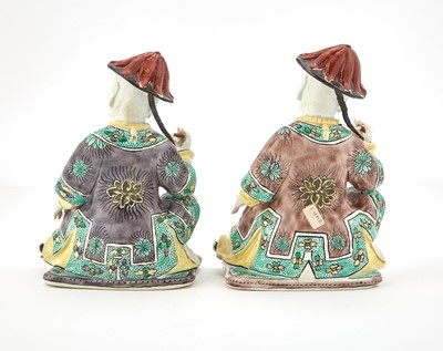 Lot 361 - Two French Enameled Porcelain Seated Mandarin Figures in the Kangxi Style