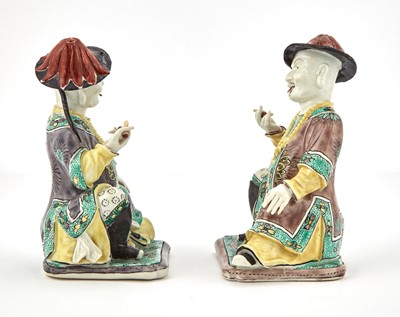 Lot 361 - Two French Enameled Porcelain Seated Mandarin Figures in the Kangxi Style