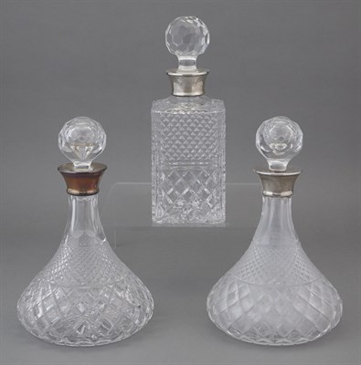 Lot 217 - Three Silver-Mounted Cut Glass Decanters...