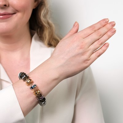 Lot 52 - Two-Color Gold, Multicolored Sapphire and Ruby Circle Link Bracelet