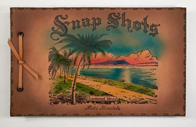 Lot 31 - [HAWAII-HULA & SURFING]
An oblong souvenir photograph album with leather covers printed in color.