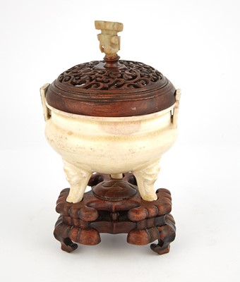 Lot 328 - A Chinese Cream Glazed Tripod Censer