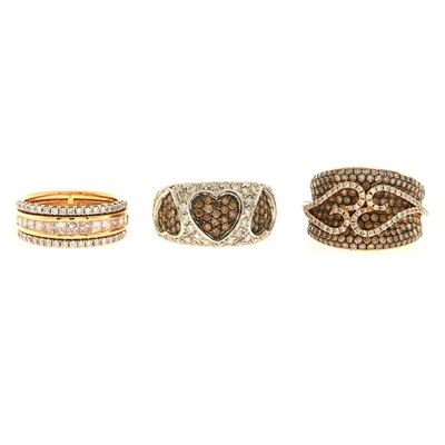 Lot 2174 - Three Rose, White and Blackened Gold, Colored Diamond and Diamond Rings