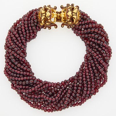 Lot 1150 - Fourteen Strand Garnet Bead Necklace with Gold and Enamel Lion Clasp