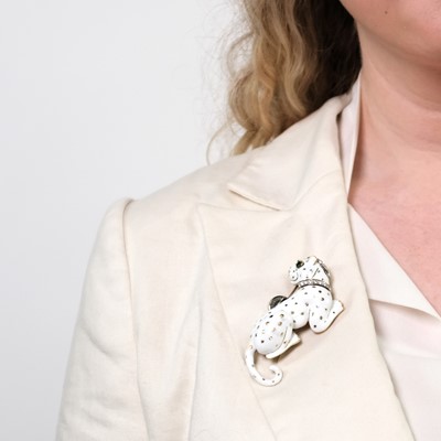 Lot 83 - David Webb Gold, Platinum, White Enamel, Diamond and Emerald Panther Clip-Brooch