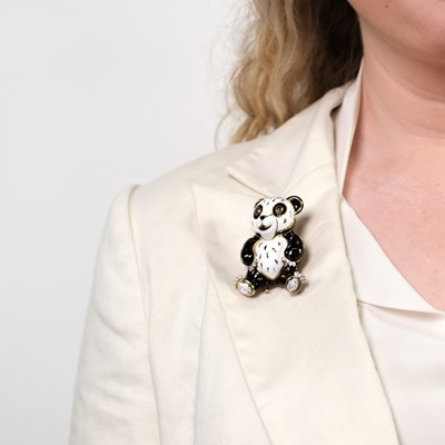 Lot 82 - David Webb Gold, Platinum, Black and White Enamel, Diamond and Cabochon Ruby Panda Bear Clip-Brooch