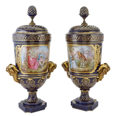 Lot 395 - Pair of Sevres Style Gilt and Polychrome Decorated Porcelain Two-Handled Urns and Covers