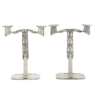 Lot 258 - Pair of Archibald Knox for Liberty & Co. Pewter & Enamel Tudric Pattern Two-Light Candelabra