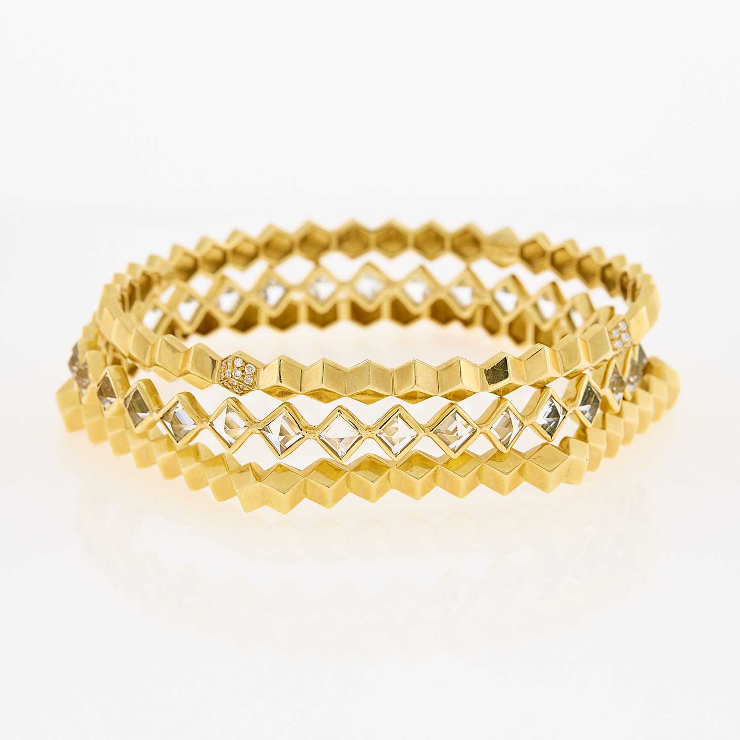 Lot 1034 - Three Gold, White Sapphire and Diamond Geometric Bangle Bracelets