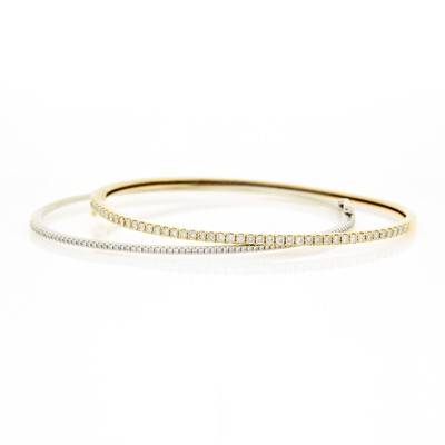 Lot 1212 - Pair of Yellow and White Gold and Diamond Bangle Bracelets