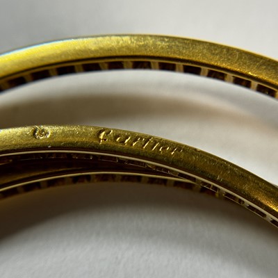 Lot 45 - Cartier Gold and Diamond 'Trintiy' Rolling Bangle Bracelet, France