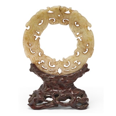 Lot 34 - A Chinese Celadon and Russet Jade Bi Disc