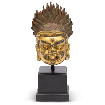 Lot 736 - A Himalayan Gilt-bronze Head of Bhairava