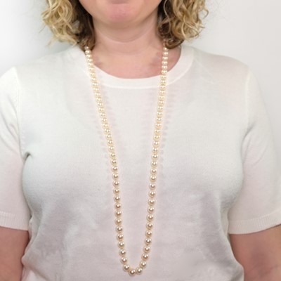 Lot 1059 - Long Cultured Pearl Necklace with Gold and Diamond Ball Clasp