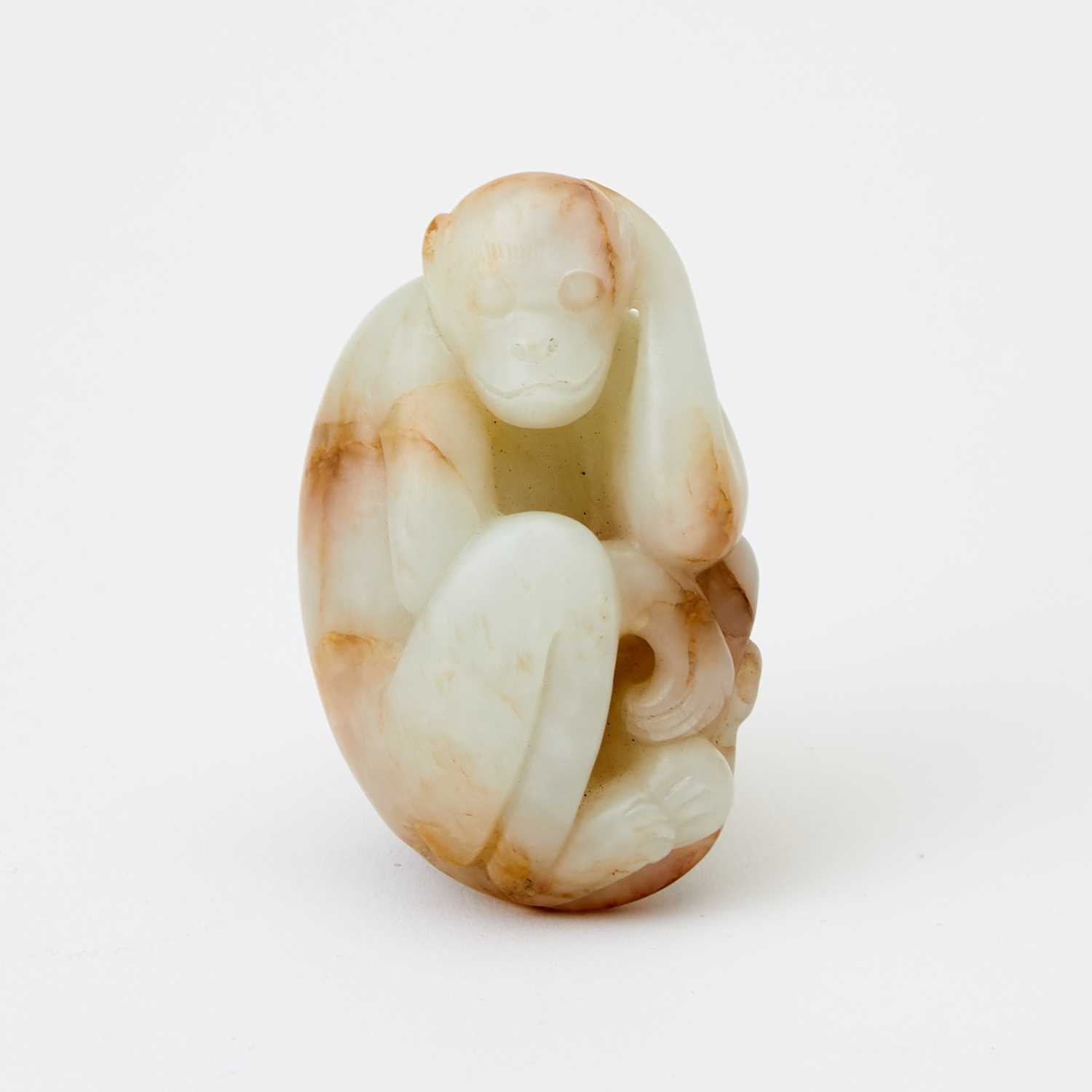 Lot 61 - A Chinese White Jade Carving of a Monkey