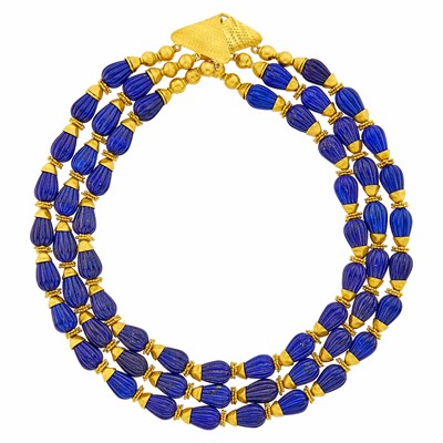 Lot 1011 - Triple Strand Gold and Carved Lapis and Gold Bead Necklace