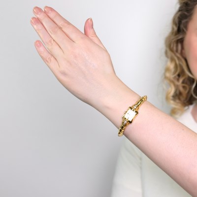 Lot 1103 - Gubelin Gold and Diamond Wristwatch