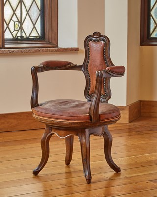 Lot 379 - Italian Rococo Leather Upholstered Carved Walnut Swivel Armchair