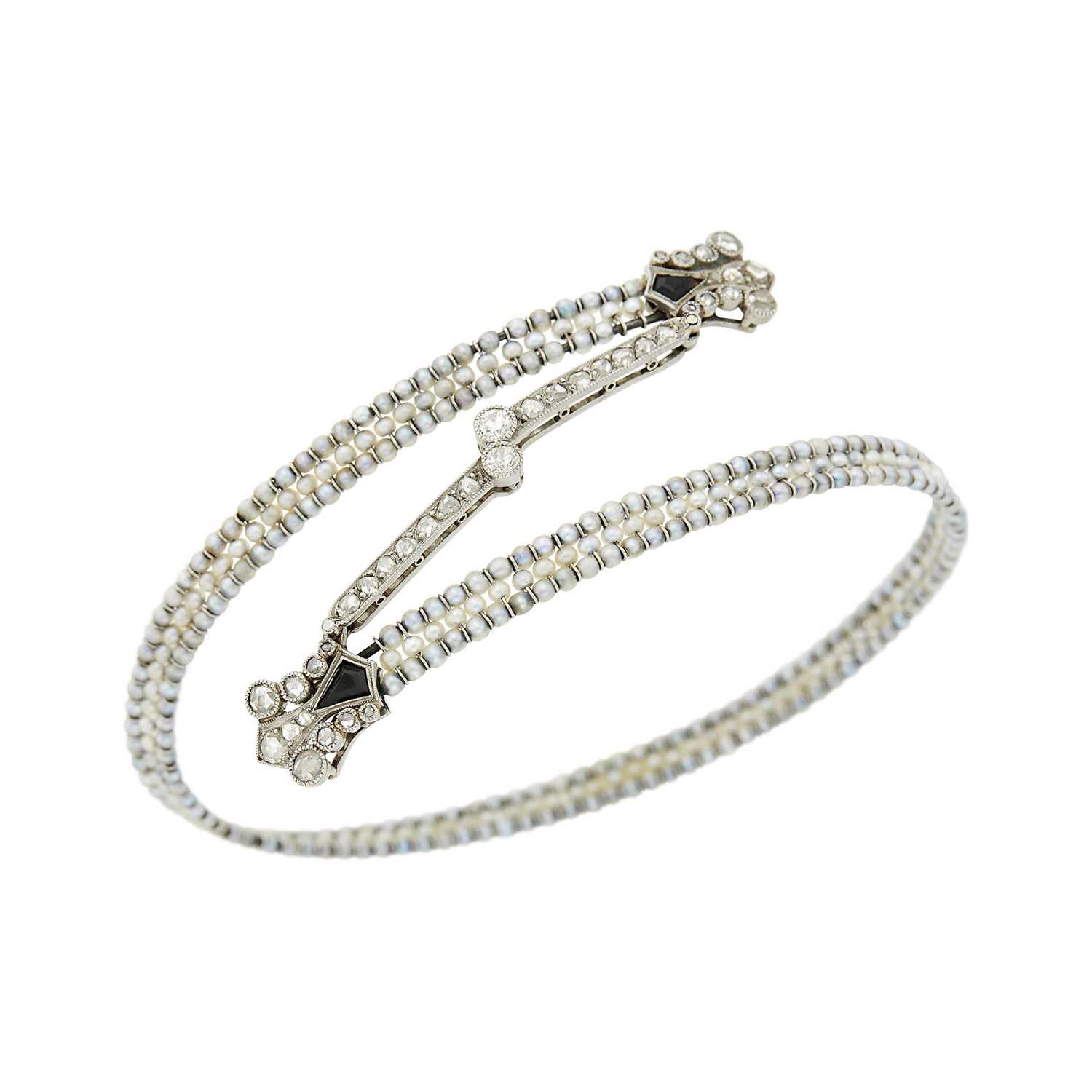 Lot 80 - Belle Époque Platinum, Seed Pearl, Diamond and Black Onyx Crossover Bangle Bracelet