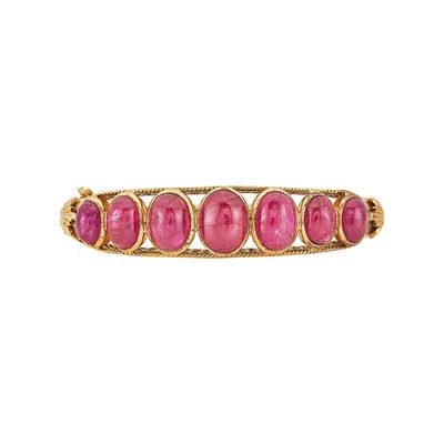 Lot 1046 - Gold and Cabochon Ruby Bangle Bracelet