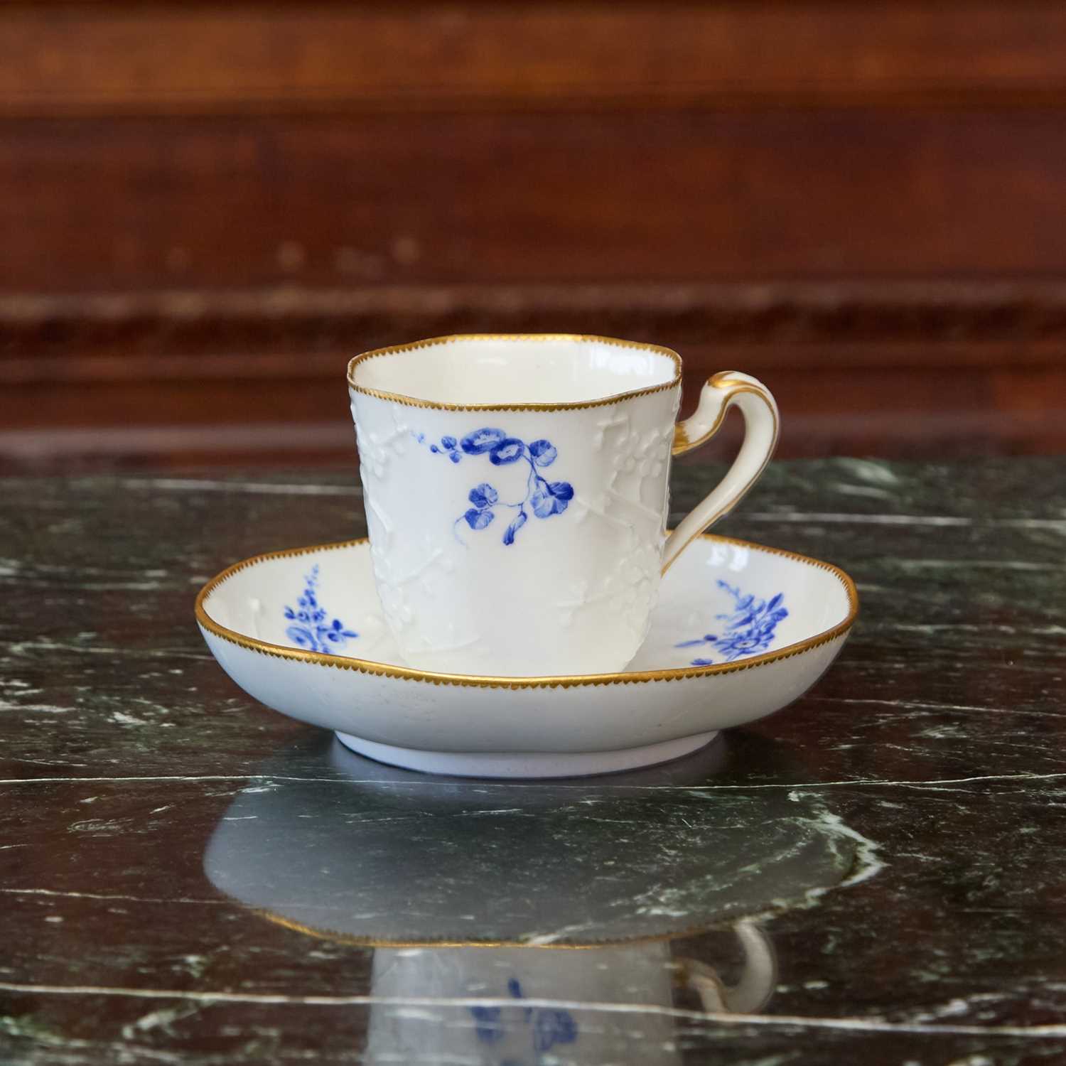 Lot 450 - VINCENNES PORCELAIN PRUNUS-MOLDED MATCHED CUP AND SAUCER (THEIERE LIZONNE A RELIEF)