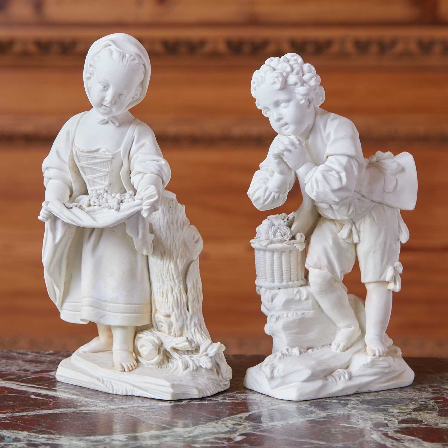 Lot 416 - Matched Pair of Sèvres Biscuit Porcelain Figures 'La Petite Fille Au Tablier' & 'Le Jeune Suppliant'