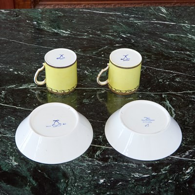 Lot 527 - TWO SEVRES PORCELAIN YELLOW-GROUND CUPS AND SAUCERS (GOBELET LITRON)