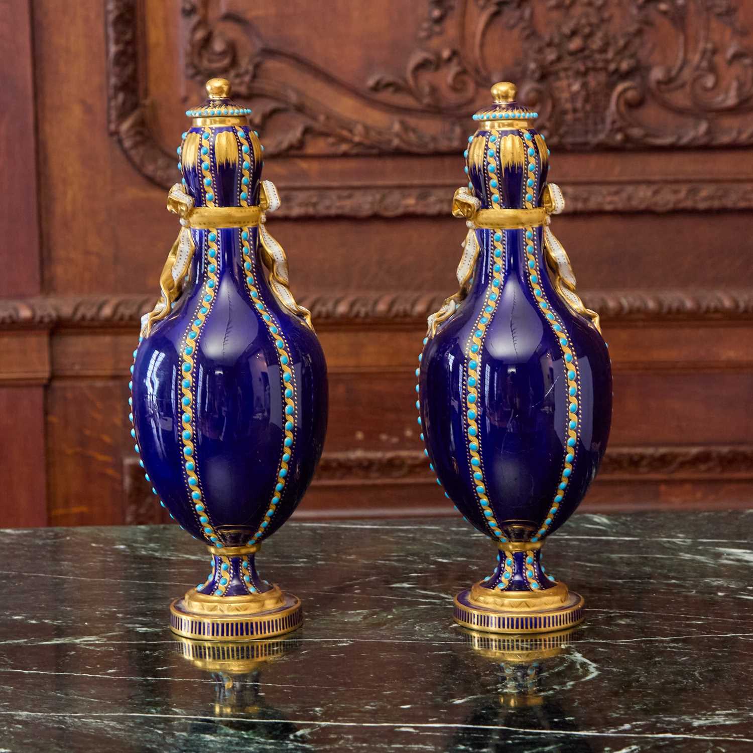 Lot 548 - PAIR OF SEVRES STYLE PORCELAIN ‘JEWELED’ COBALT-BLUE GROUND VASES AND COVERS
