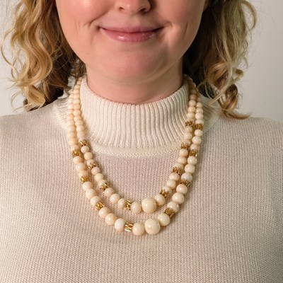 Lot 173 - Van Cleef & Arpels Double Strand White and Angel Skin Coral and Gold Link Necklace with Gold and Diamond Clasp