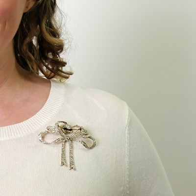 Lot 167 - Belle Époque Platinum, Gold and Diamond Bow Brooch