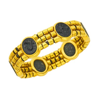 Lot 69 - Elizabeth Gage Triple Strand Hammered Gold and Lava Rock Intaglio Bracelet