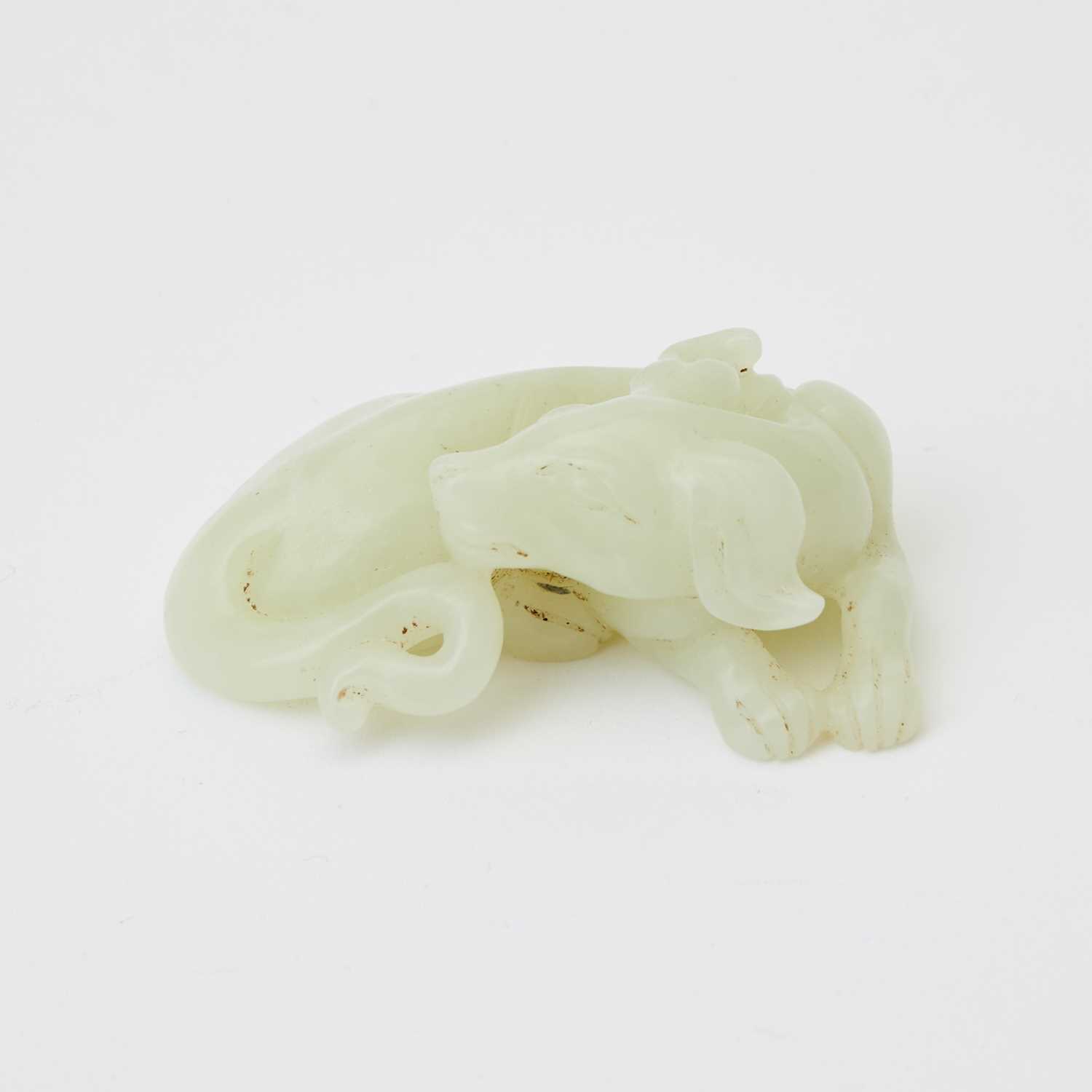 Lot 28 - A Chinese Celadon Light Jade Carving of a Hound