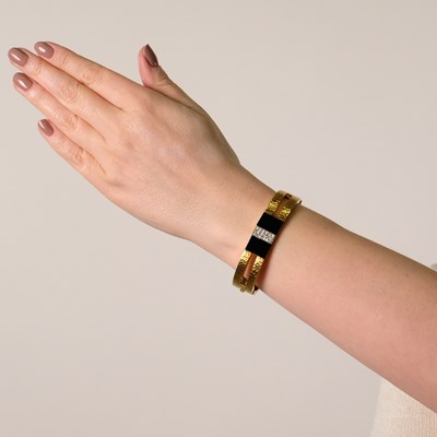 Lot 167 - Hammered Gold, Black Onyx and Diamond Bangle Bracelet