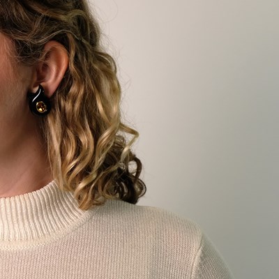 Lot 162 - Verdura Pair of Gold, Black Onyx and Citrine 'Cross-Over' Twisted Riboon Earclips