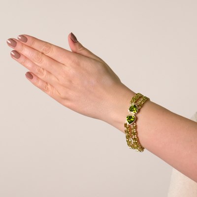 Lot 116 - Four Strand Gold, Peridot and Diamond Bracelet