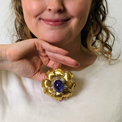 Lot 66 - Gold, Platinum, Color-Change Star Sapphire and Diamond Flower Pendant