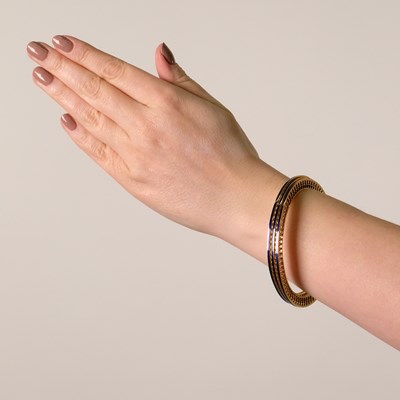 Lot 102 - Tiffany & Co., Paloma Picasso Three Gold and Blue Enamel 'Venezia' Bangle Bracelets