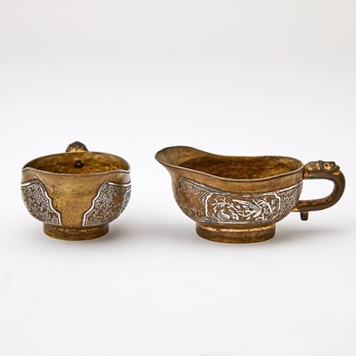 Lot 101 - A Pair of Chinese Parcel-Gilt and Inlaid-Silver Bronze Libation Cups