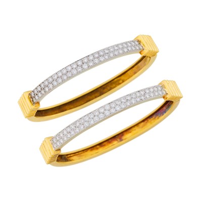 Lot 1143 - Pair of Two-Color Gold and Diamond Bangle Bracelets