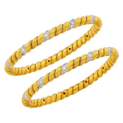 Lot 77 - Georges L'Enfant for Van Cleef & Arpels Pair of Fluted Gold, Platinum and Diamond Bangle Bracelets, France