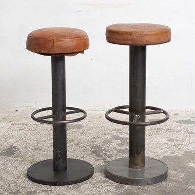 Lot 389 - Two Leather Upholstered Patinated Metal Bar Stools