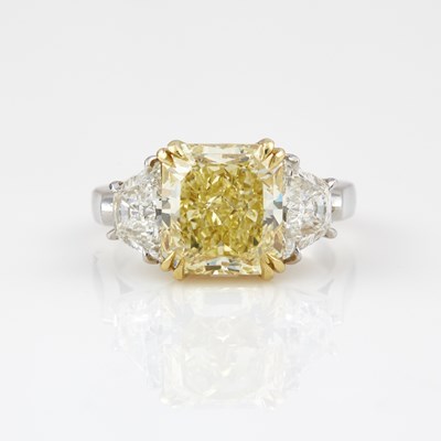 Lot 281 - Diamond Engagement Ring, 3 diamonds, center stone about 4.41 cts. Natural Fancy Yellow, Platinum and18K 5 dwt. with copy of GIA Report #21052973