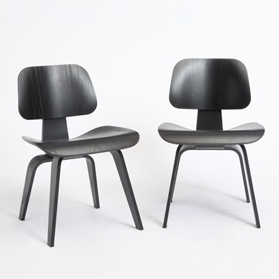 Lot 361 - Set of Four Charles and Ray Eames Dark Stained Plywood DCW Chairs