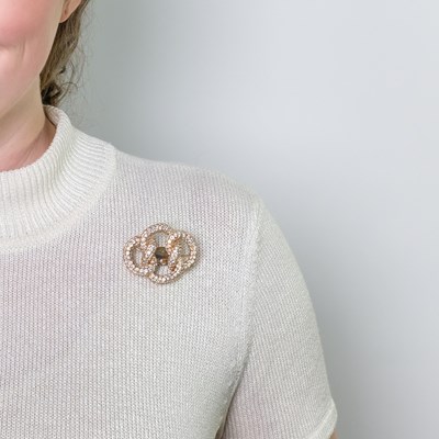 Lot 100 - Gold and Diamond Knot Brooch