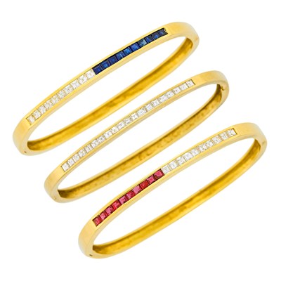 Lot 122 - Three Gold, Diamond, Ruby and Sapphire Bangle Bracelets