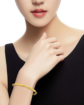 Lot 2 - Tiffany & Co. Gold Bamboo Bangle Bracelet and Pair of Hoop Earrings